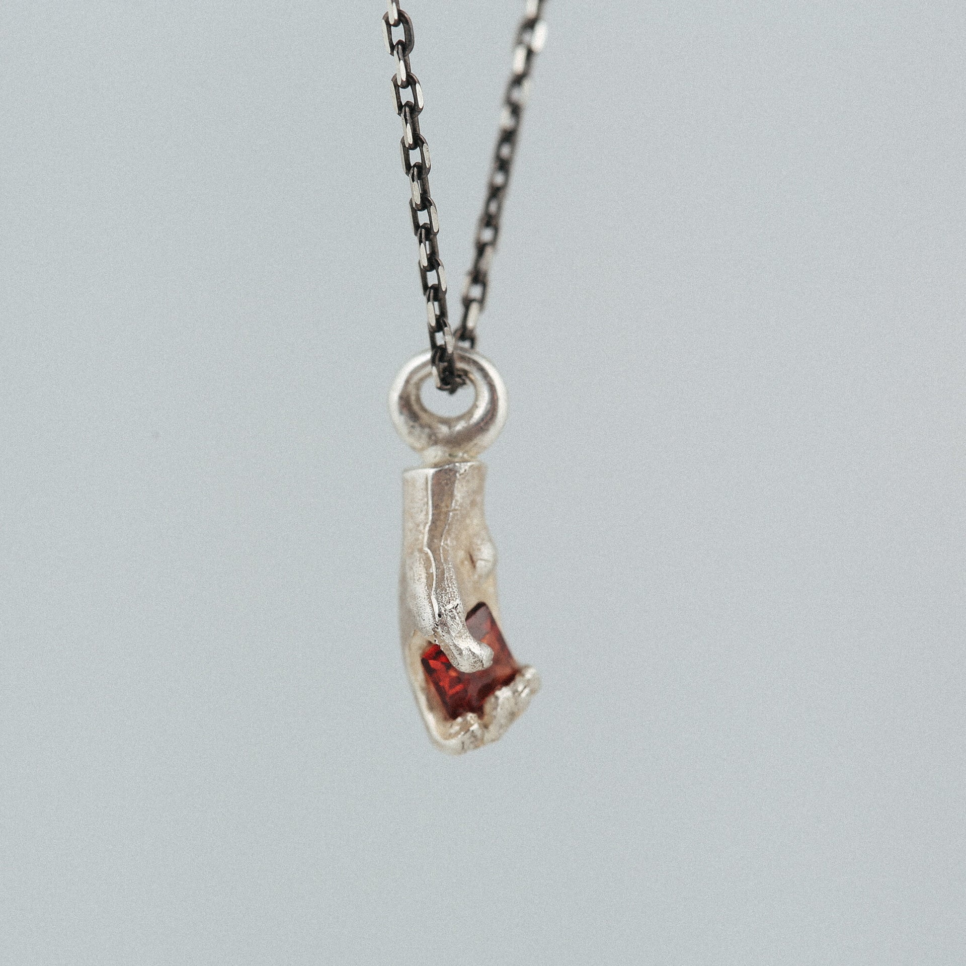 square-heart-silver-hand-pendant-with-garnet