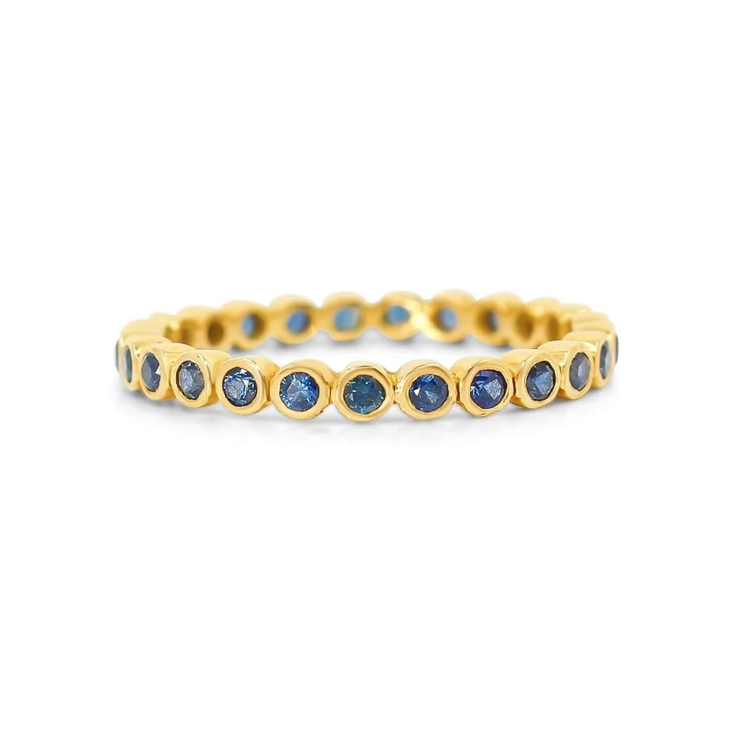 gold-blue-sapphire-bezel-eternity-ring